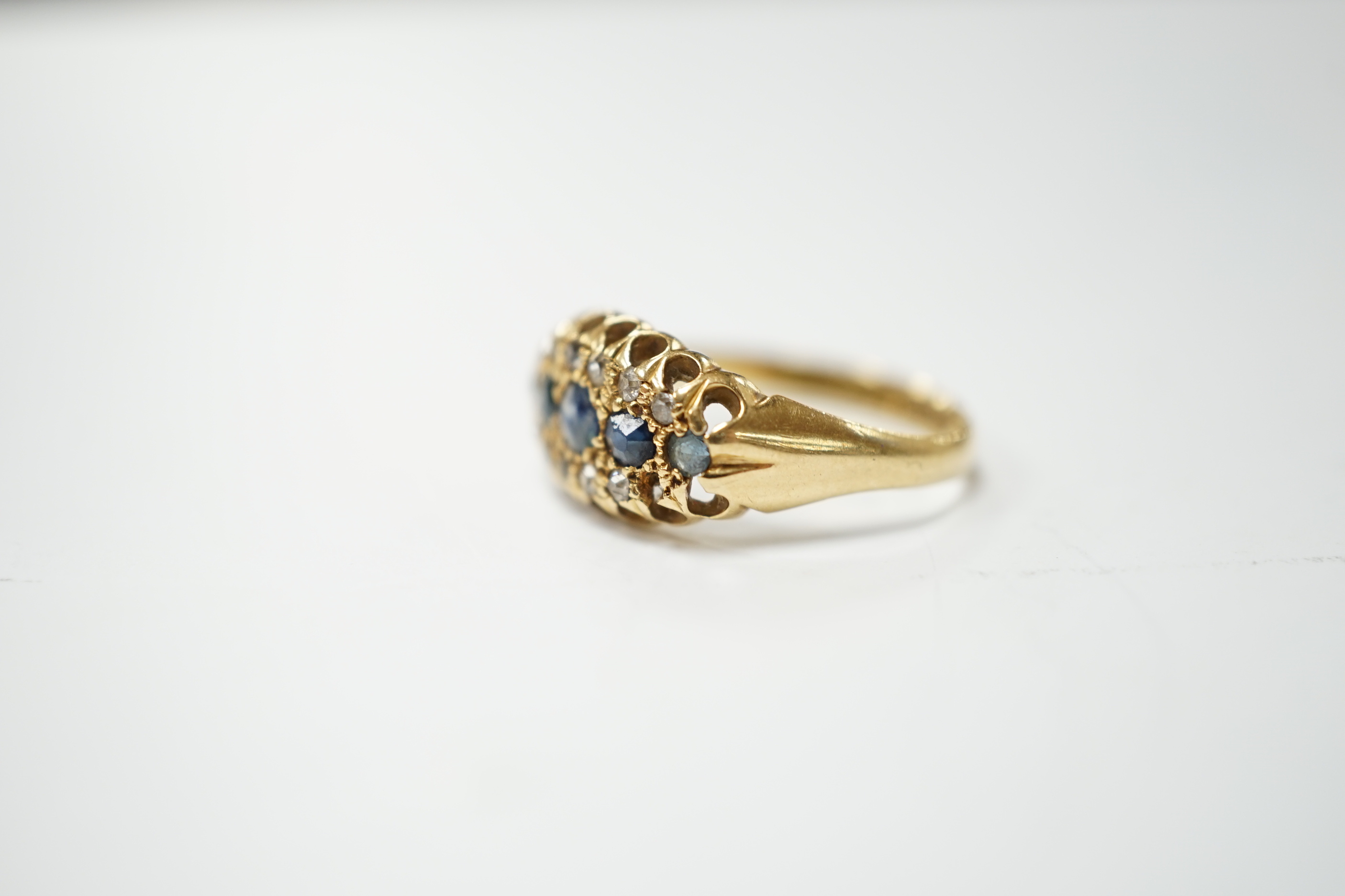 A George V 18ct gold, sapphire and diamond cluster set navette shaped ring, size N, gross weight 2.7 grams.